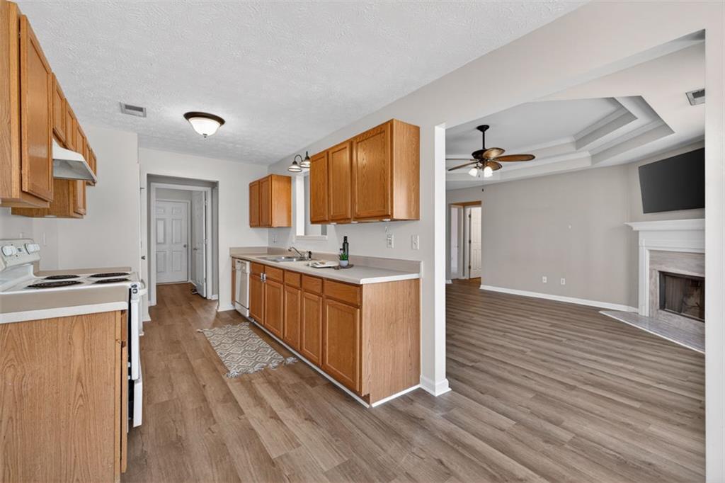 775 Sterling Place Monroe, GA 30656 - Photo 12 of 37 a kitchen with stainless steel appliances granite countertop a stove top oven and sink