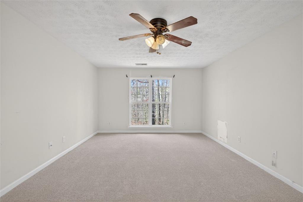 775 Sterling Place Monroe, GA 30656 - Photo 16 of 37 an empty room with a window and a fan