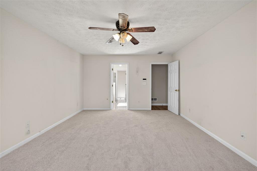 775 Sterling Place Monroe, GA 30656 - Photo 18 of 37 a view of an empty room with a ceiling fan