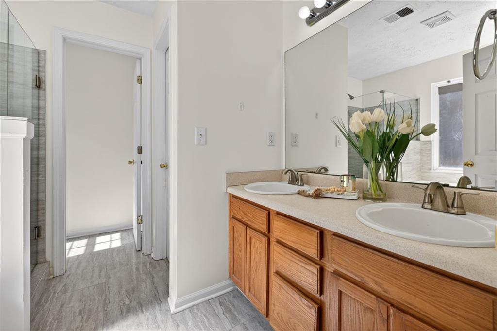 775 Sterling Place Monroe, GA 30656 - Photo 21 of 37 a bathroom with a double vanity sink and a mirror