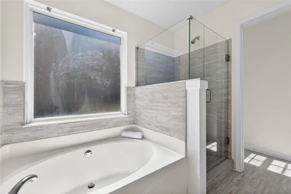 a bathroom with a bathtub and a shower