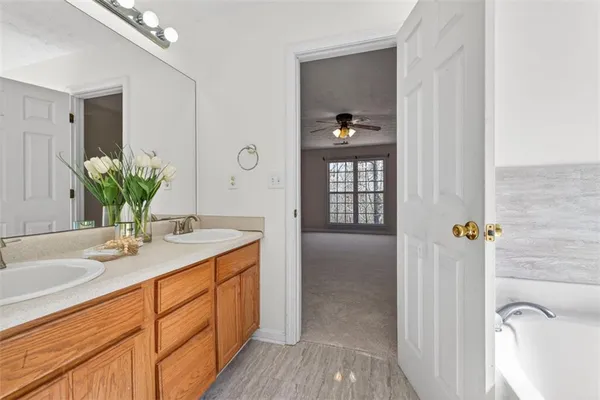 a en suite bathroom with a granite countertop sink and a mirror