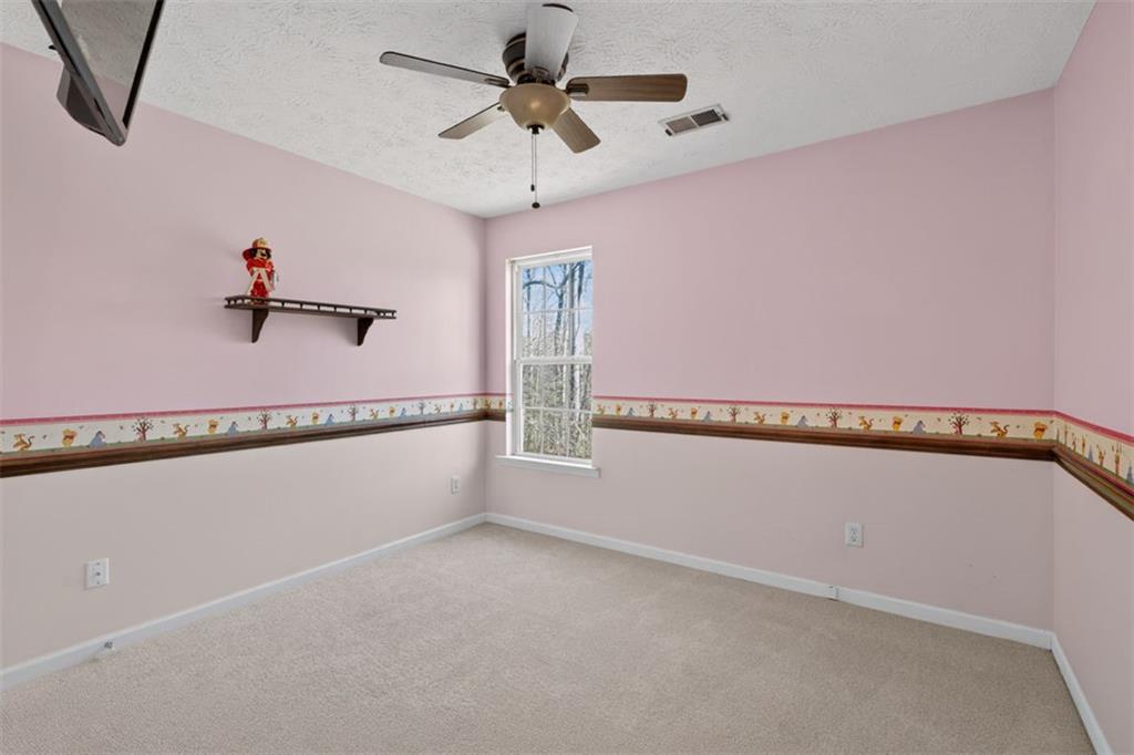 775 Sterling Place Monroe, GA 30656 - Photo 25 of 37 a view of a water heater and a ceiling fan in a room