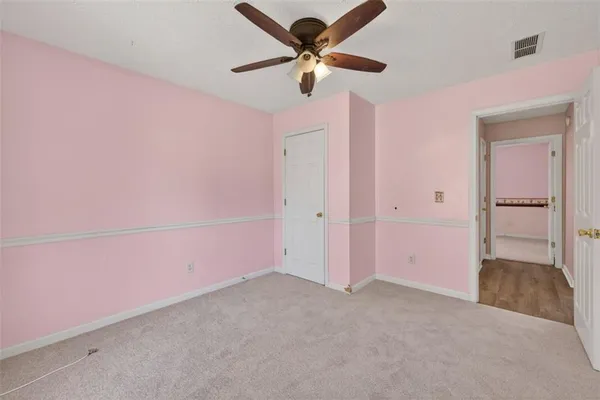 a view of a livingroom with a ceiling fan and window