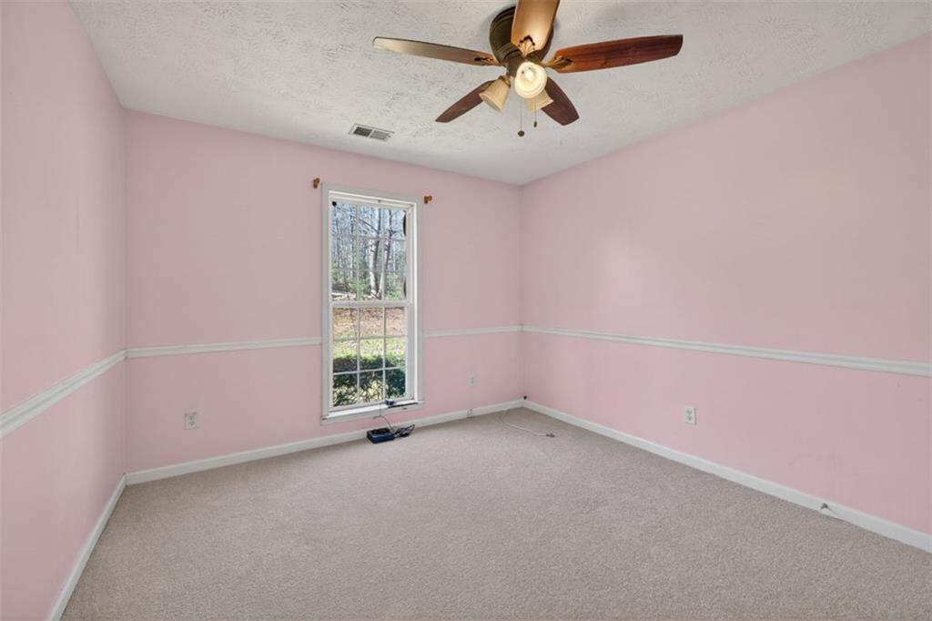 775 Sterling Place Monroe, GA 30656 - Photo 29 of 37 an empty room with a window and a fan