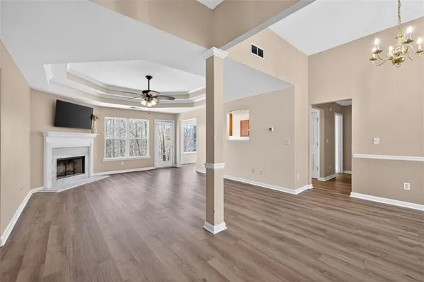a view of a livingroom with wooden floor a fireplace and window