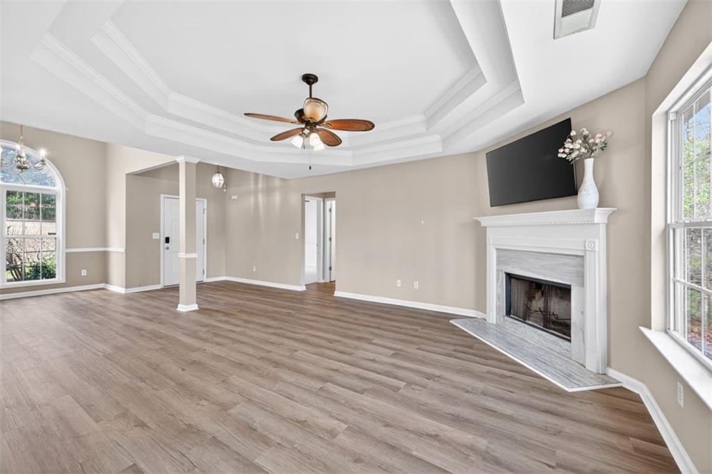 775 Sterling Place Monroe, GA 30656 - Photo 6 of 37 a view of an empty room with wooden floor fireplace and a window