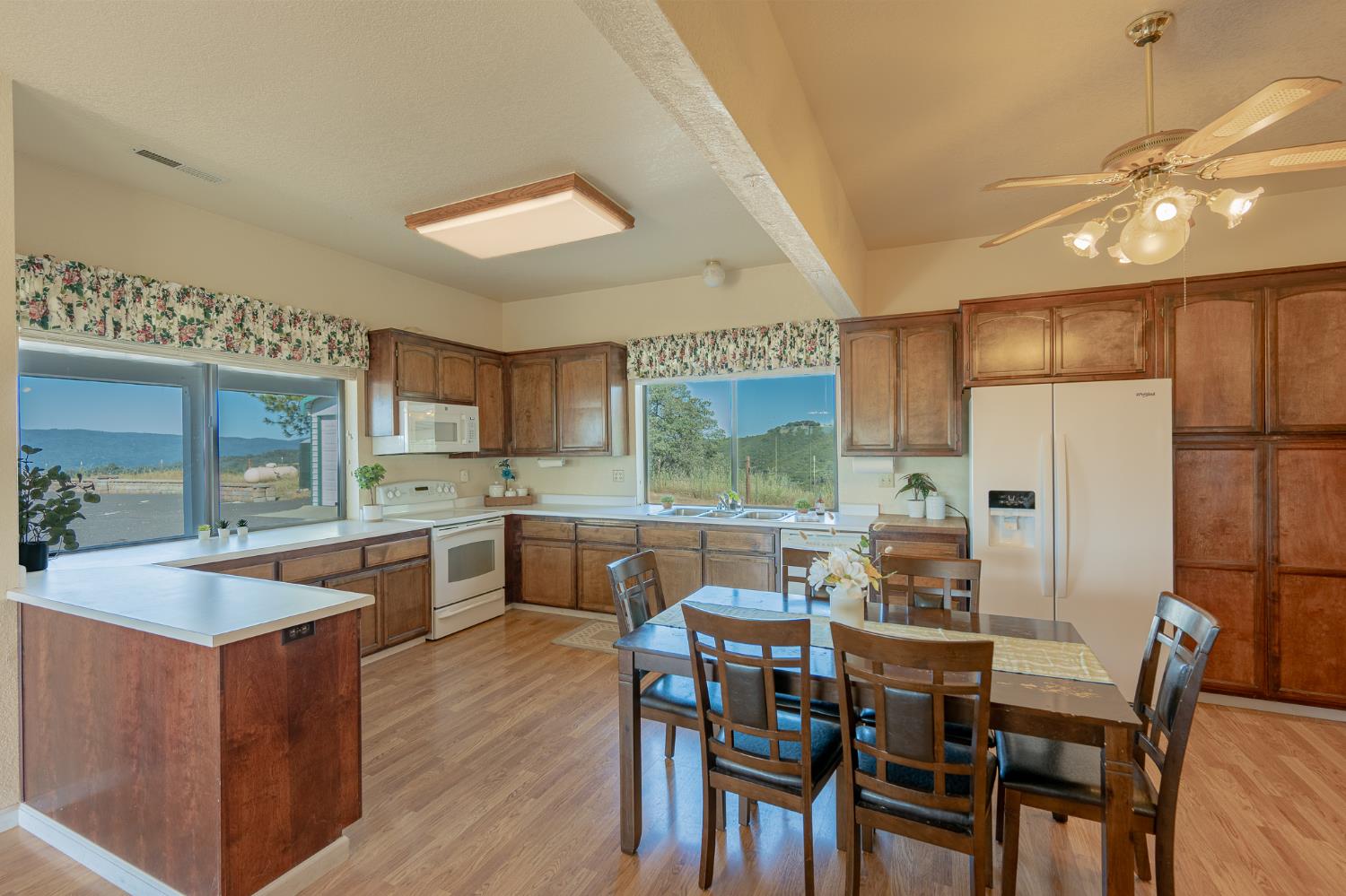 5912 Old Gulch Road San Andreas, CA 95249 - Photo 3 of 71 a kitchen with stainless steel appliances kitchen island granite countertop a table chairs sink and cabinets