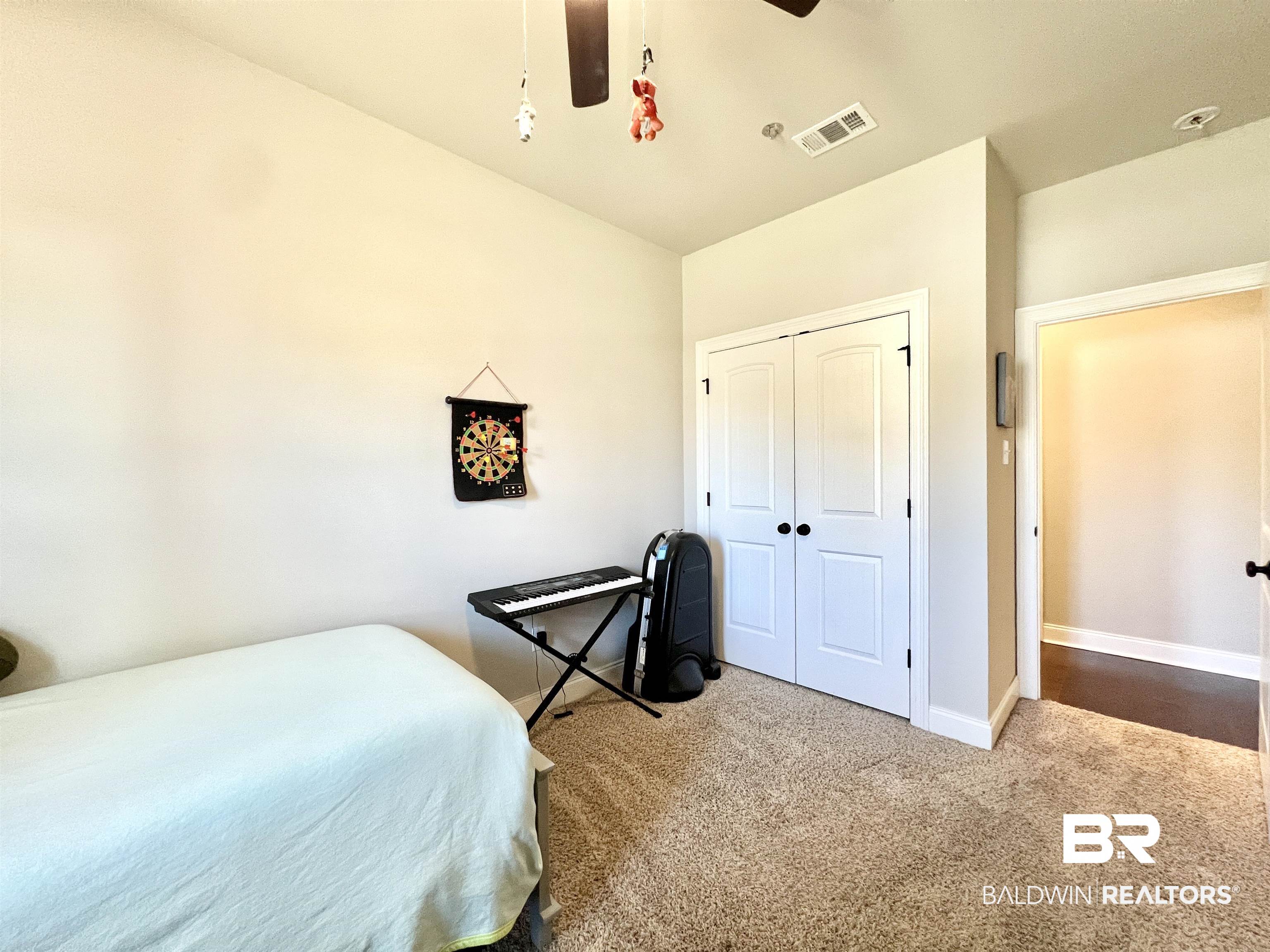 32290 Calder Court Daphne, AL 36527 - Photo 29 of 59 Bedroom featuring carpet, a closet, and ceiling fan
