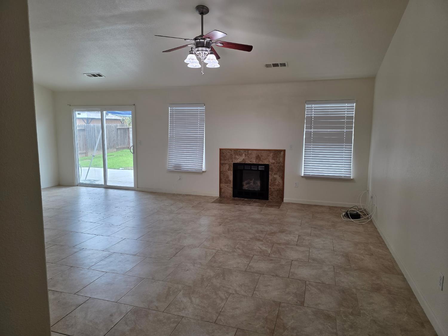 804 Morris Lane Madera, CA 93637 - Photo 2 of 17 an empty room with windows and fireplace