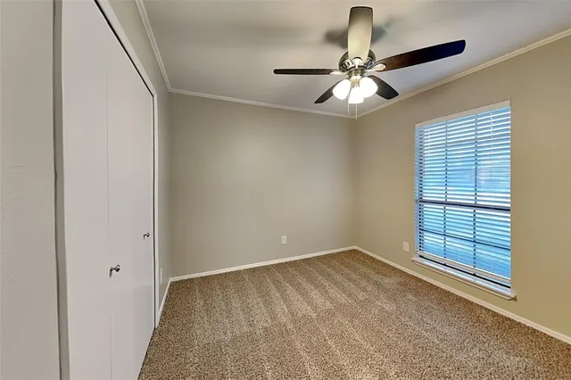 a view of room with window and ceiling fan