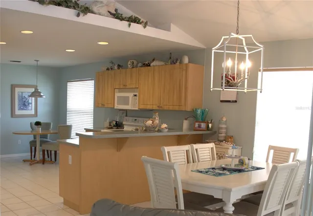 a kitchen with a dining table chairs and a coffee table