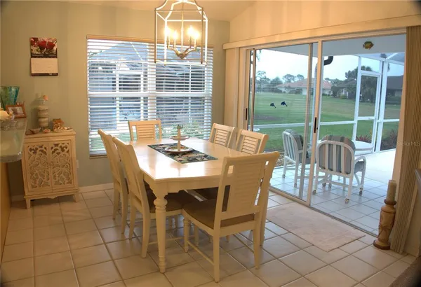 a view of a dining room with furniture and a chandelier