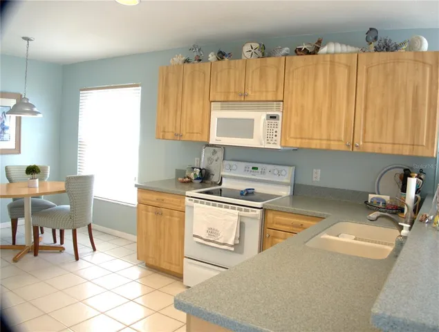 a kitchen with a sink cabinets and window