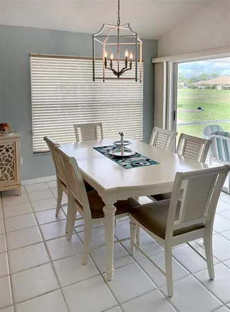 a kitchen with a dining table chairs and microwave