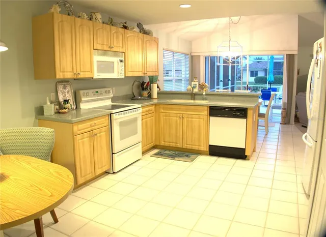 a kitchen with stainless steel appliances granite countertop a sink and cabinets