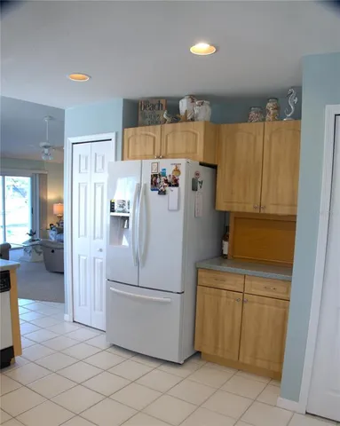 a kitchen with a refrigerator and cabinets