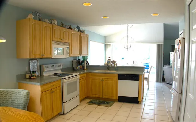 a kitchen with a sink cabinets and appliances