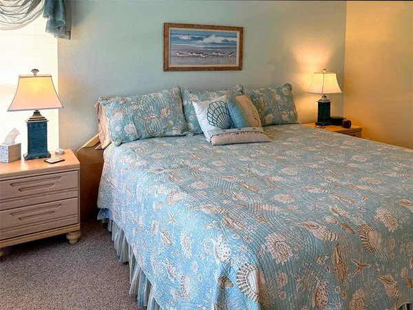 a spacious bedroom with a bed next to a window