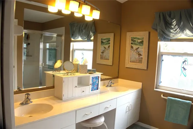 a bathroom with a sink a mirror and a window