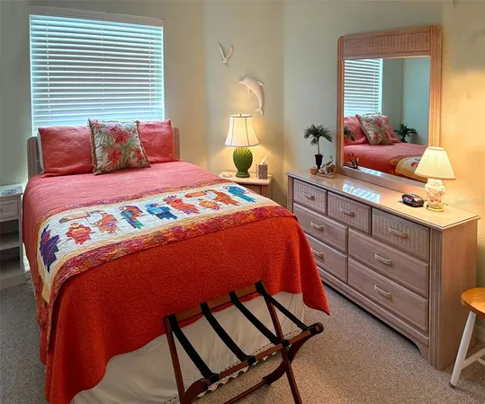 a view of a swimming pool with a table and chairs under an umbrella