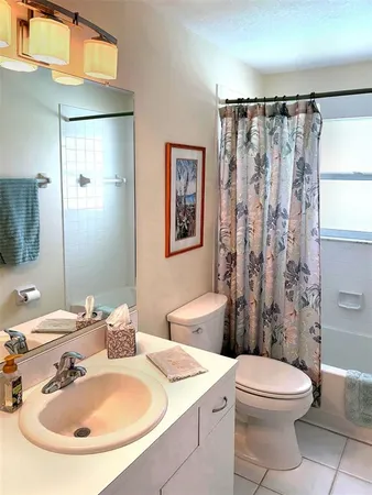 a view of a patio with couches table and chairs under an umbrella