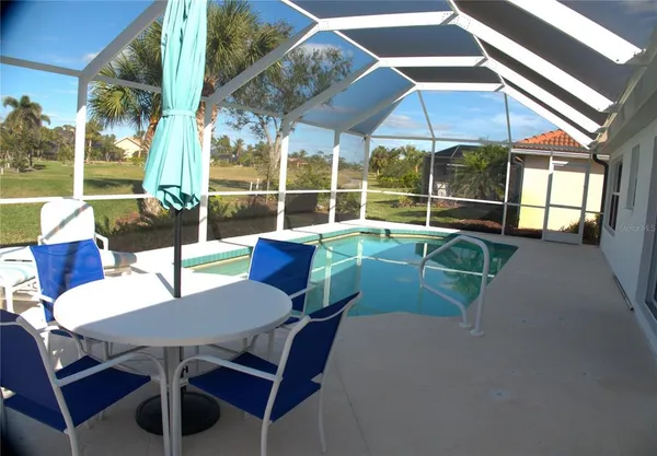 a view of a patio with a table and chairs