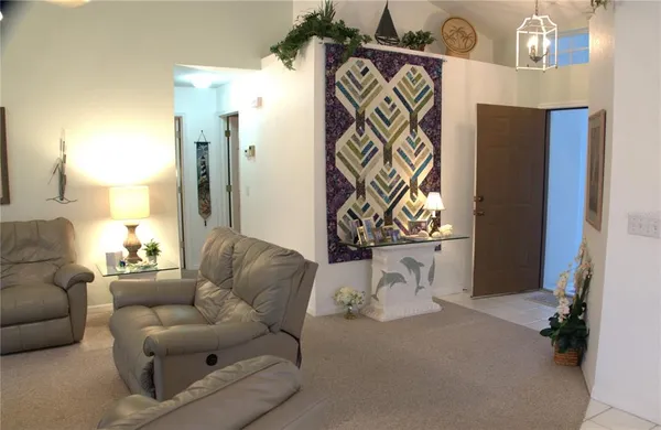 a living room with furniture and a chandelier