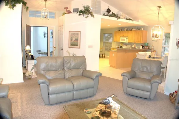 a living room with fireplace furniture and a floor to ceiling window