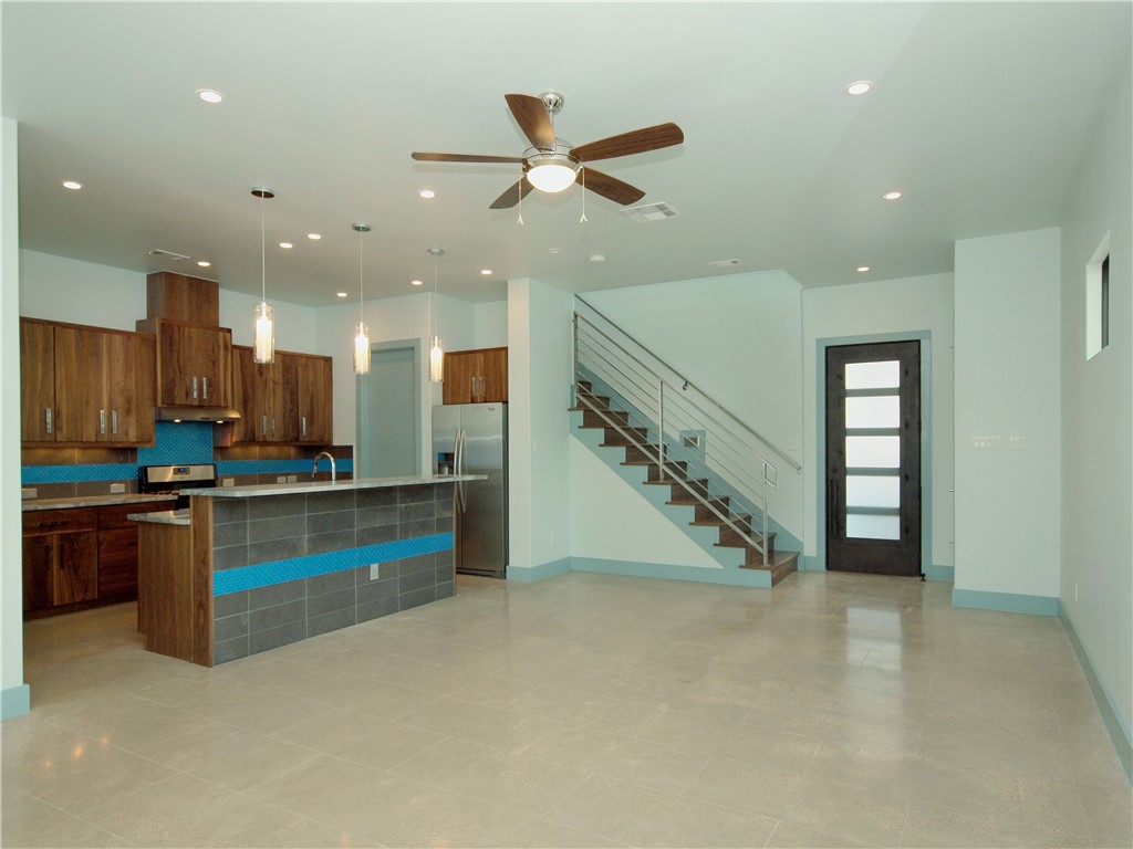 a view of kitchen and kitchen with stainless steel appliances wooden floor