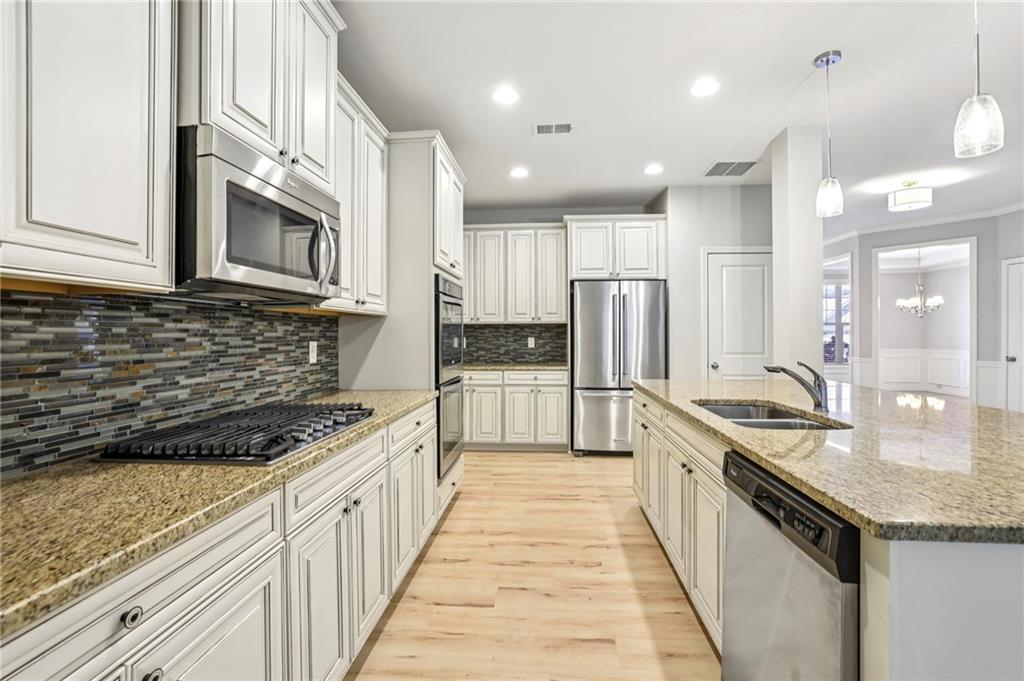 1210 Roswell Manor Circle Roswell, GA 30076 - Photo 11 of 43 a kitchen with stainless steel appliances granite countertop a stove a sink and a refrigerator