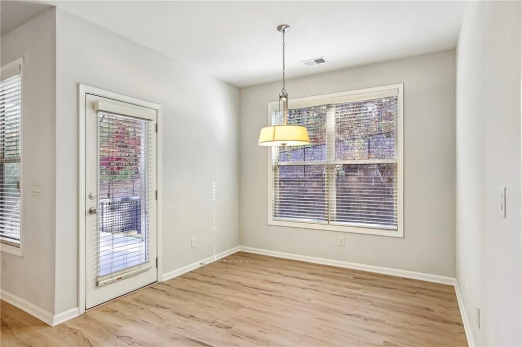 1210 Roswell Manor Circle Roswell, GA 30076 - Photo 13 of 43 a view of an empty room with wooden floor and a window