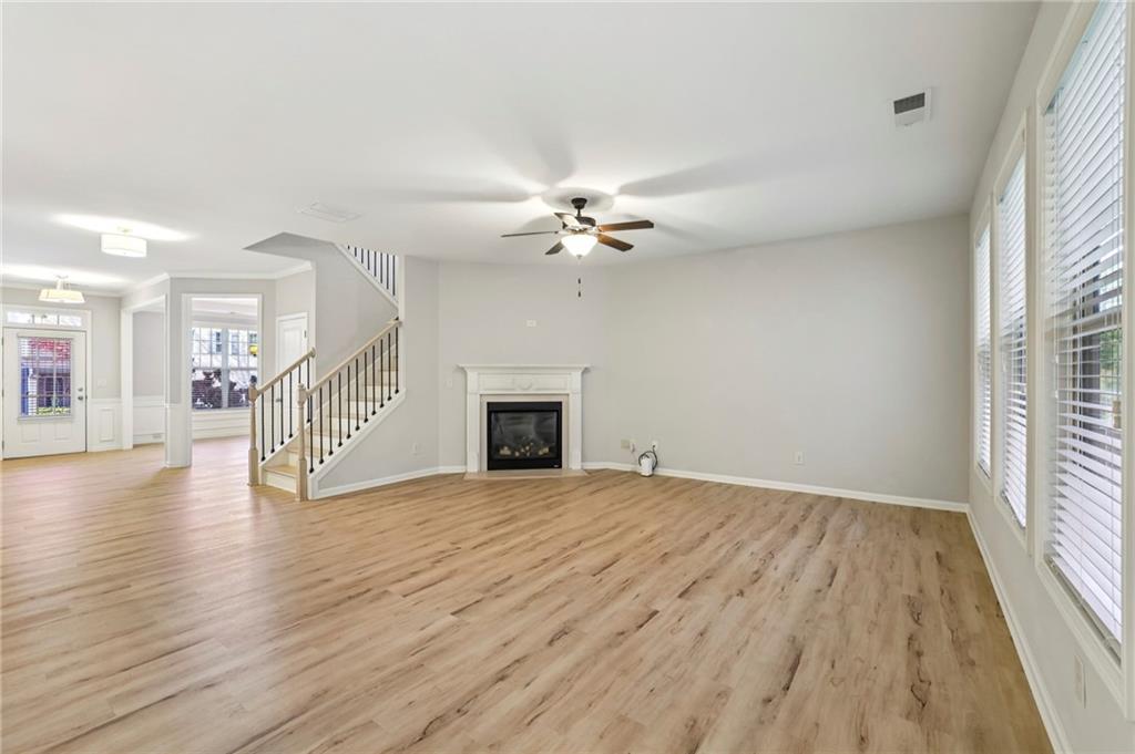 1210 Roswell Manor Circle Roswell, GA 30076 - Photo 14 of 43 a view of an empty room with wooden floor fireplace and a window
