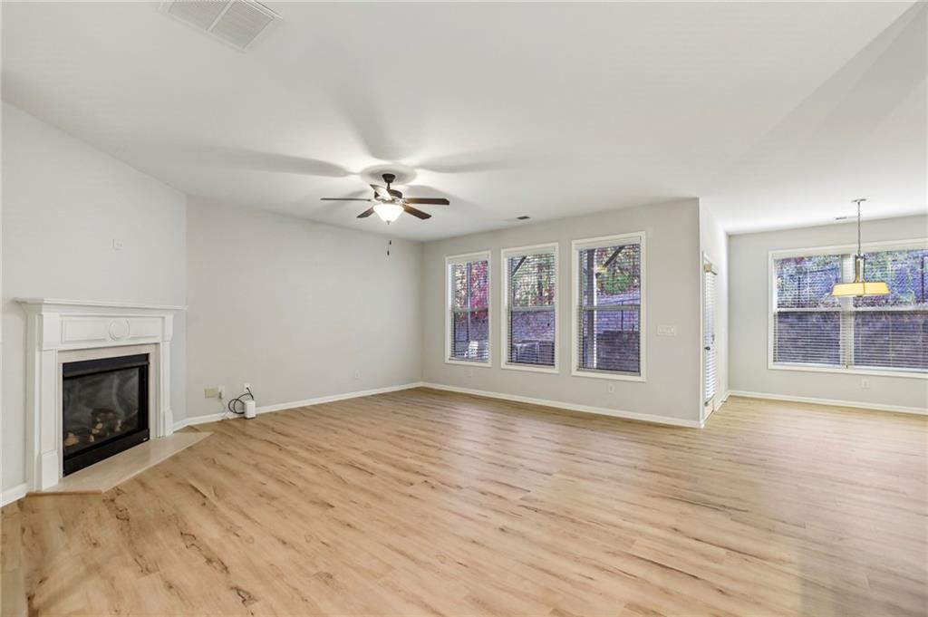1210 Roswell Manor Circle Roswell, GA 30076 - Photo 16 of 43 a view of empty room with wooden floor and fireplace