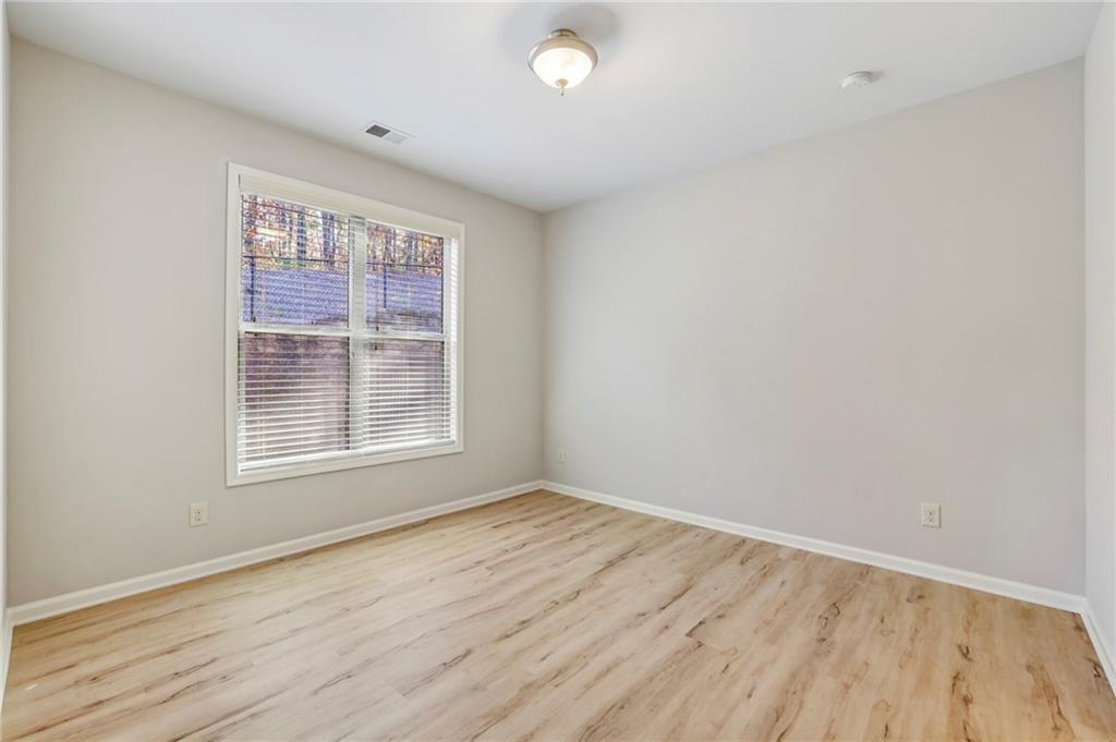 1210 Roswell Manor Circle Roswell, GA 30076 - Photo 19 of 43 an empty room with wooden floor and windows