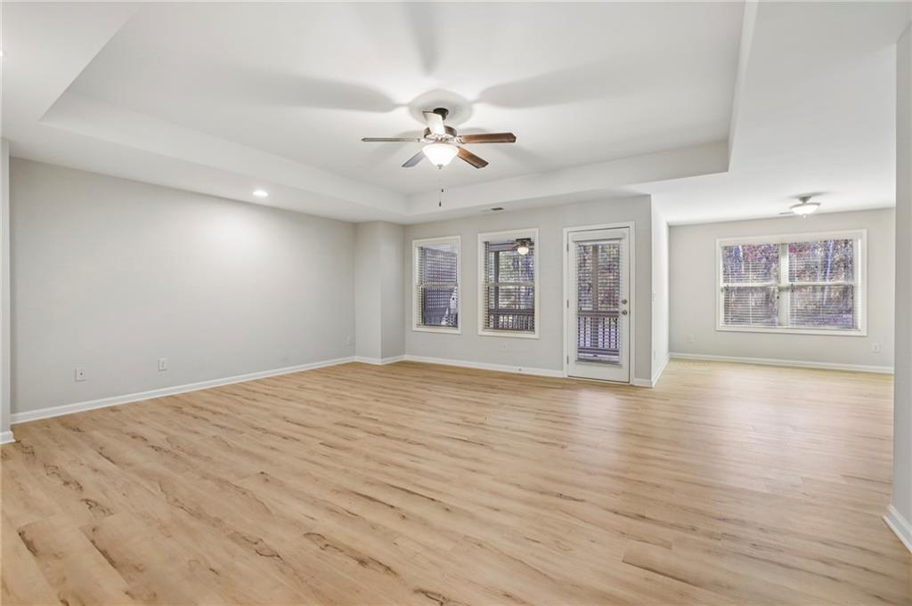1210 Roswell Manor Circle Roswell, GA 30076 - Photo 21 of 43 a view of an empty room with window and wooden floor