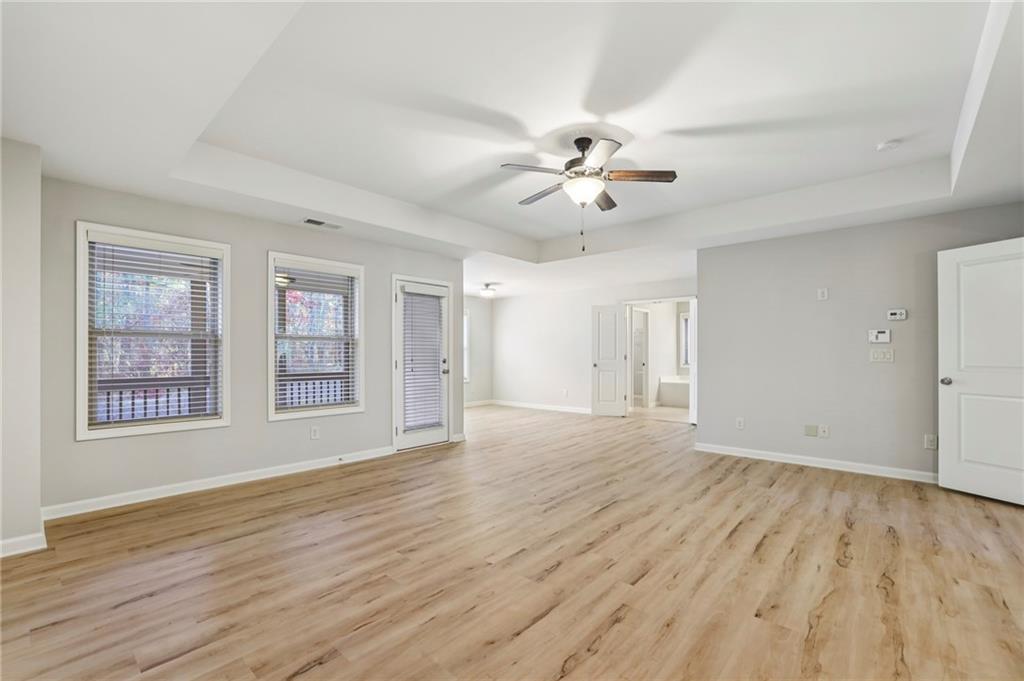 1210 Roswell Manor Circle Roswell, GA 30076 - Photo 22 of 43 a view of an empty room with a window and wooden floor