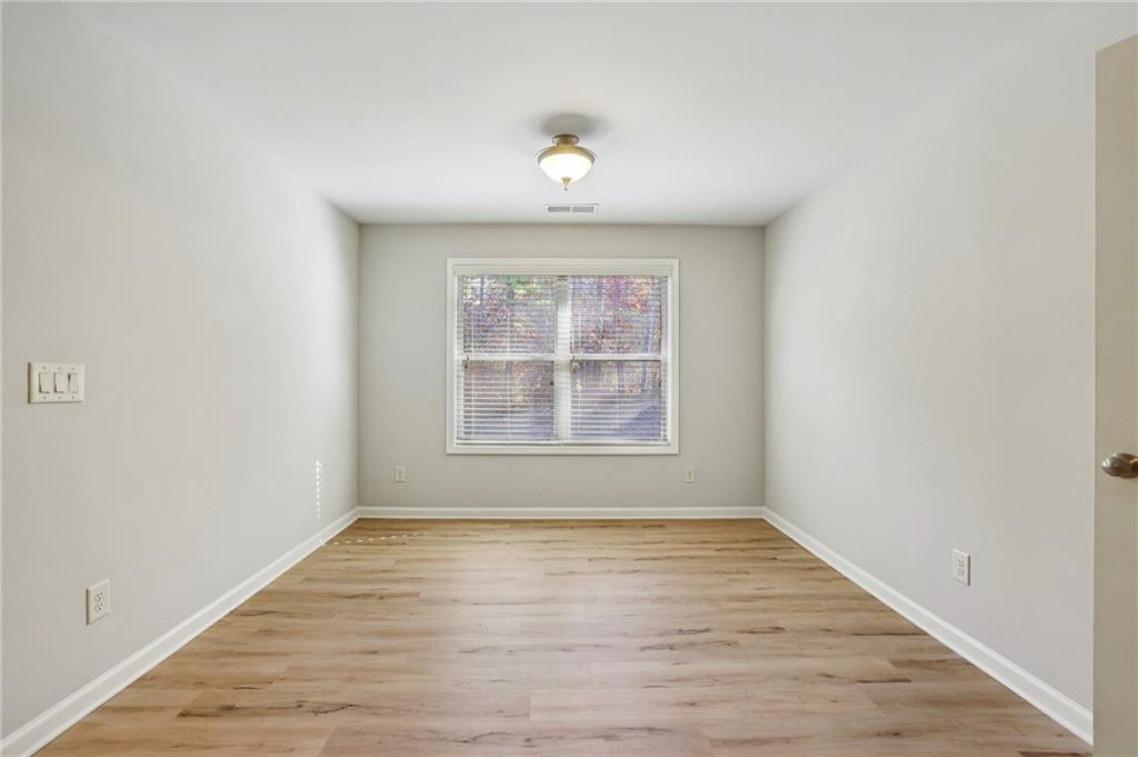 1210 Roswell Manor Circle Roswell, GA 30076 - Photo 24 of 43 an empty room with wooden floor and windows