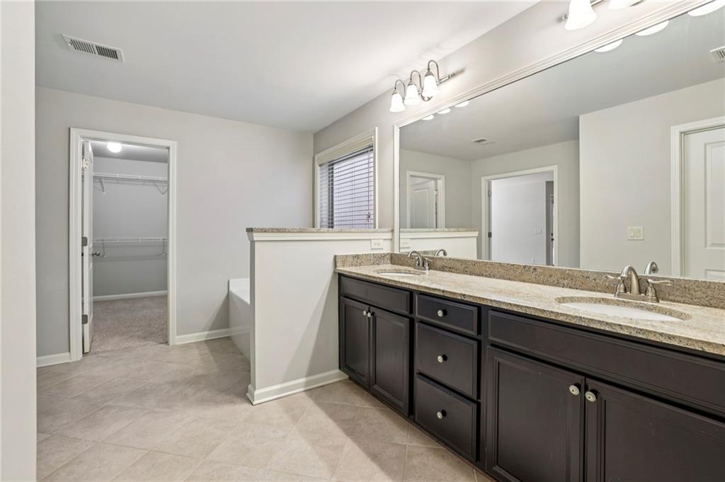 1210 Roswell Manor Circle Roswell, GA 30076 - Photo 27 of 43 a spacious bathroom with a double vanity sink mirror and toilet