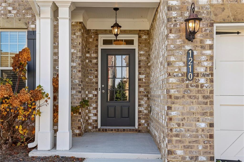 1210 Roswell Manor Circle Roswell, GA 30076 - Photo 3 of 43 a front view of a building with a door and a window