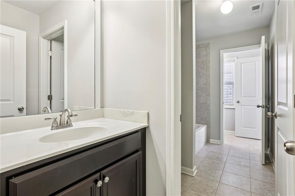 1210 Roswell Manor Circle Roswell, GA 30076 - Photo 32 of 43 a bathroom with a sink and a mirror