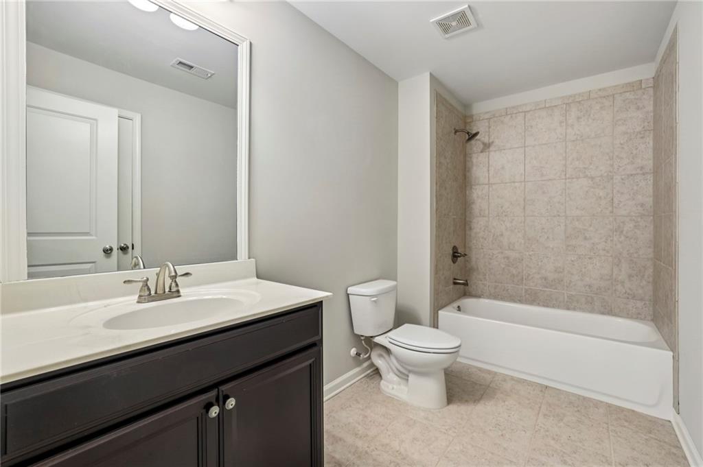 1210 Roswell Manor Circle Roswell, GA 30076 - Photo 35 of 43 a bathroom with a sink a toilet and a mirror