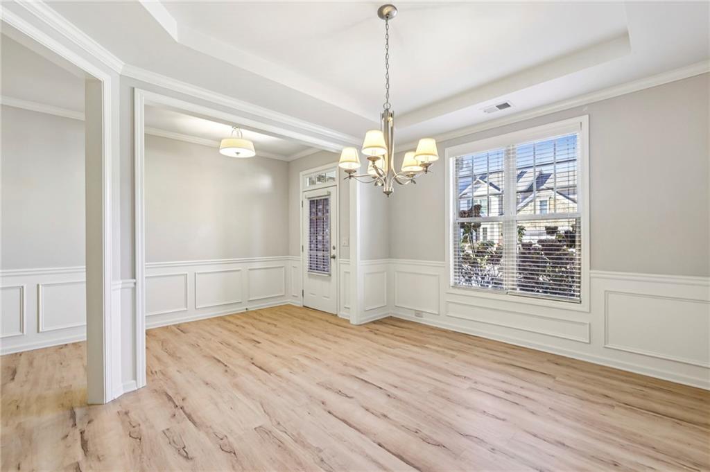 1210 Roswell Manor Circle Roswell, GA 30076 - Photo 6 of 43 a view of a room with wooden floor ceiling fan and windows