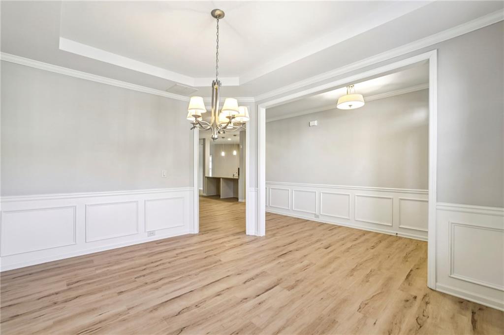 1210 Roswell Manor Circle Roswell, GA 30076 - Photo 7 of 43 a view of a room with wooden floor staircase and a kitchen space