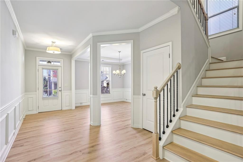 1210 Roswell Manor Circle Roswell, GA 30076 - Photo 9 of 43 a view of a hallway with wooden floor and staircase