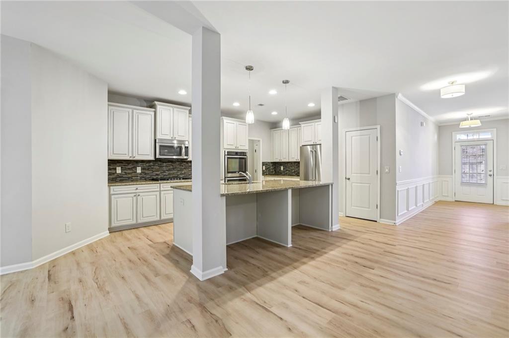 1210 Roswell Manor Circle Roswell, GA 30076 - Photo 10 of 43 a kitchen with white cabinets and appliances
