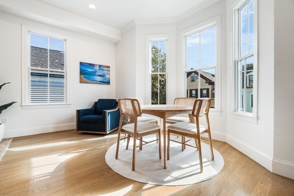 560 East 5th Street, Unit 2 Boston, MA 02127 - Photo 18 of 27 a dining room with furniture a floor to ceiling window and wooden floor