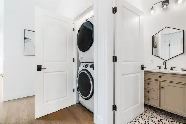 a bathroom with a granite countertop sink a toilet and shower