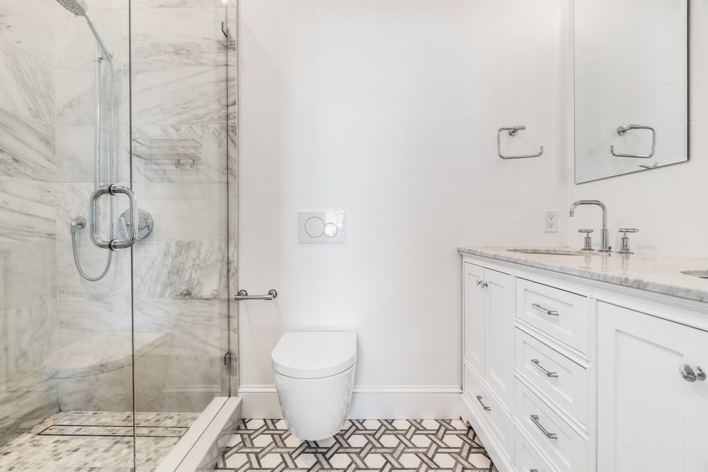 560 East 5th Street, Unit 2 Boston, MA 02127 - Photo 20 of 27 a bathroom with a granite countertop sink a toilet and shower