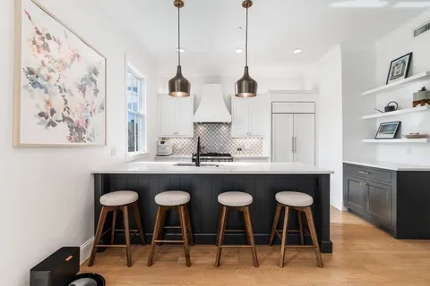 a kitchen with stainless steel appliances granite countertop a stove a sink and a refrigerator